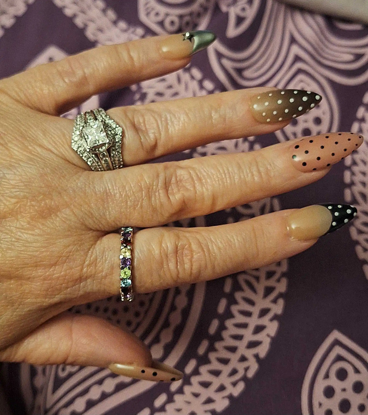 Close up look of handmade polka dot almond nails set 