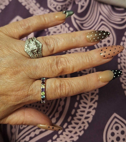Close up look of handmade polka dot almond nails set 