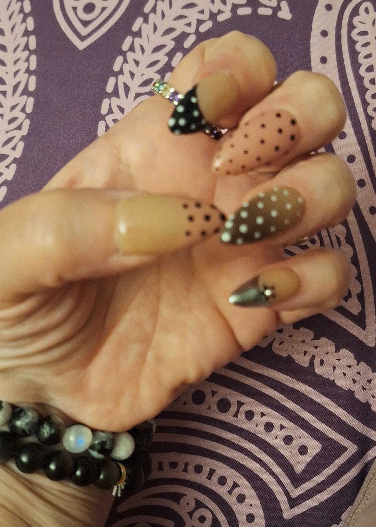Customer wearing handmade polka dot almond nails from musemoodnails