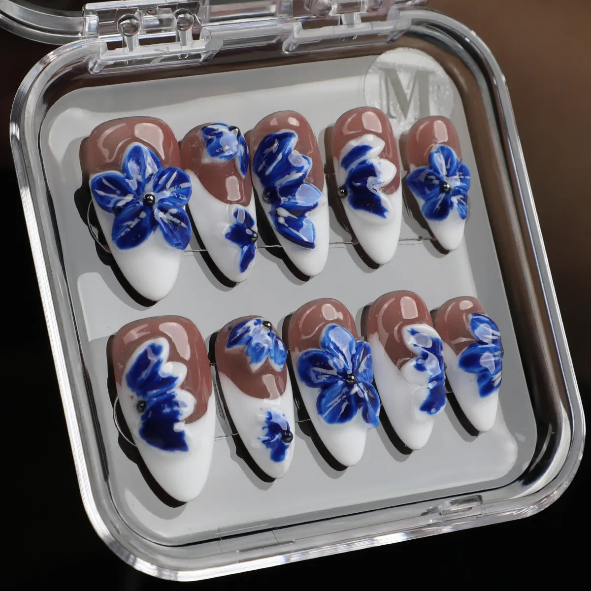 Blue and white French tip press-on nails with floral design