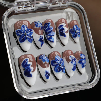 Blue and white French tip press-on nails with floral design