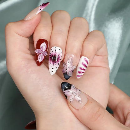 Short almond press-on nails with pink flowers and polka dots