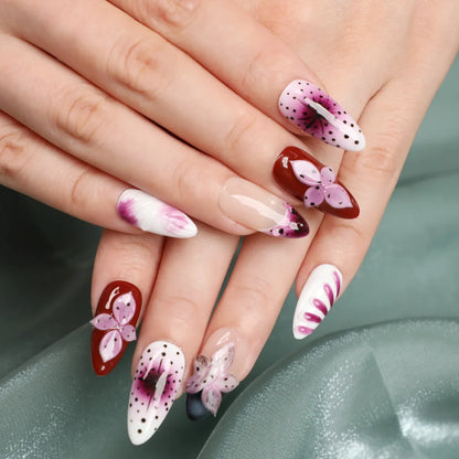 Close up picture of whole set of pink floral medium almond handmade acrylic press-on nails